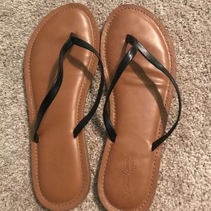 Black faux leather flip flops